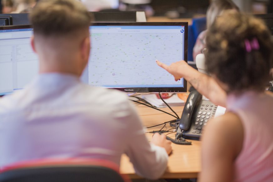 jobs in logistics showing two transport controllers working on a tracking screen
