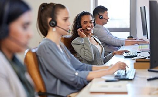 Portrait,,Woman,And,Colleagues,In,A,Call,Center,Office,For Portrait, woman and colleagues in a call center office for customer service, consulting and business crm. Female advisor and staff, inbound telemarketing and microphone to listen, help and support