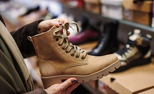 Woman,Is,Choosing,And,Buying,Stylish,Leather,Ankle,Boots,In Woman is choosing and buying stylish leather ankle boots in shoe store. Shopping trendy shoes